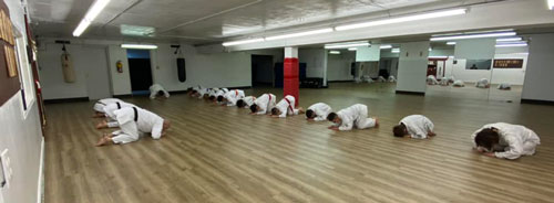 students bowing before class